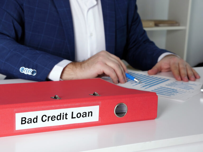 A male loan executive with a file of bad credit loan contracts