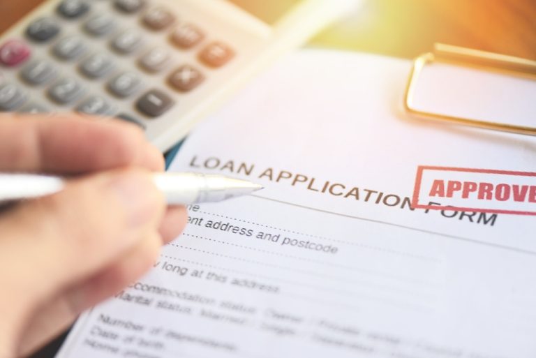 Pen and approval form for a 1-hour loan approval service.