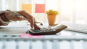 Borrower using a loan charge calculator for a quick assessment