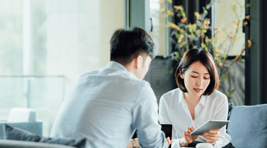 Financial officer meeting with the customer in a professional setting, highlighting the reliable services of an authorised private money lender in Singapore.