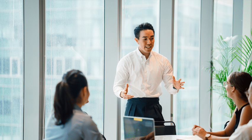 Financial staff meeting with customers in a professional and friendly setting, showcasing the services of an authorised money lender in Singapore.